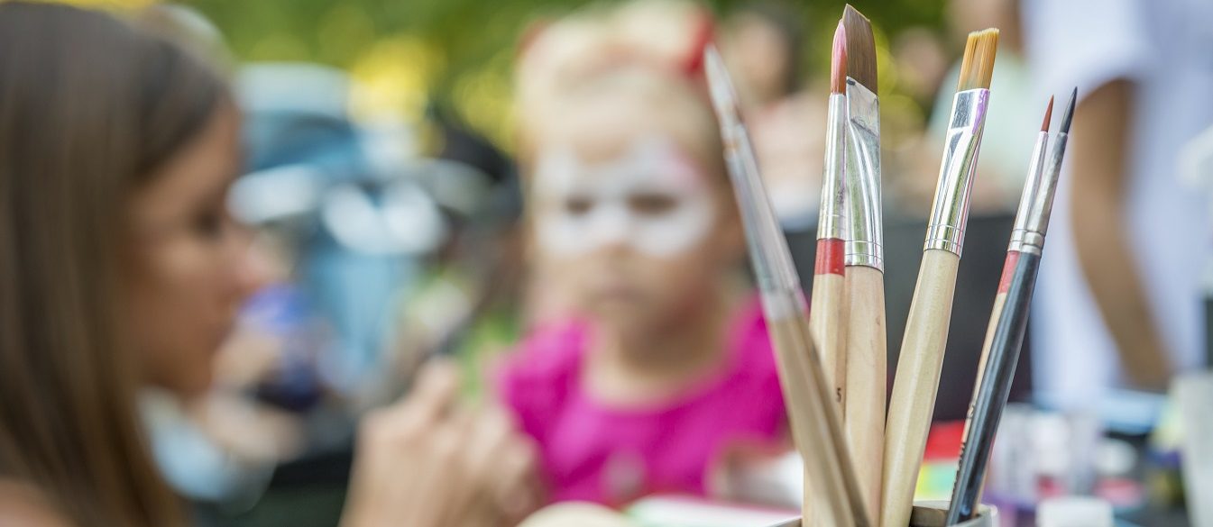 Image of children at a festival with face-painting.